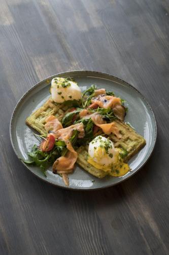 a plate of food with eggs and toast on a table at Empire City in Karagandy