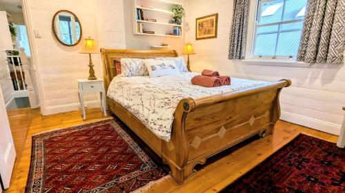 a bedroom with a wooden bed with a rug at Charm & History 3bdr Cottage in Waverton, close to harbour views in Sydney