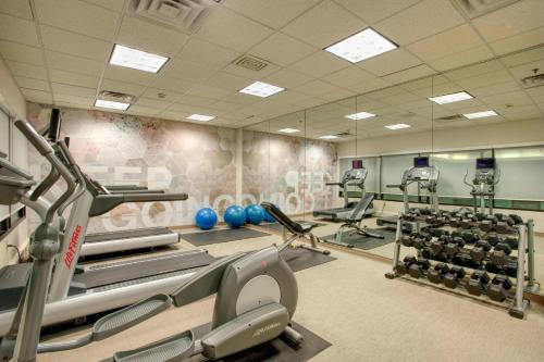 a gym with treadmills and exercise equipment in it at SpringHill Suites by Marriott Lawrence Downtown in Lawrence