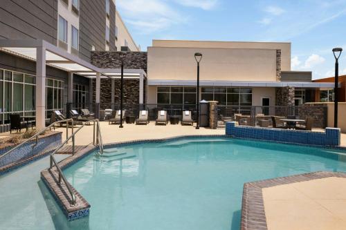a large swimming pool in front of a building at SpringHill Suites by Marriott Midland Odessa in Midland