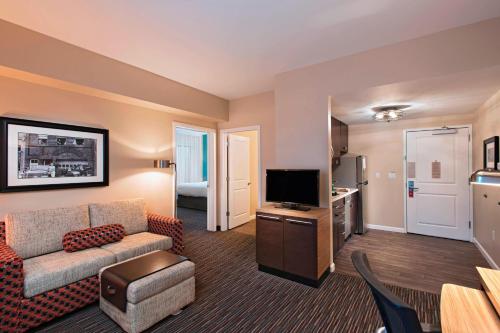 a living room with a couch and a tv at TownePlace Suites by Marriott Des Moines West/Jordan Creek in West Des Moines