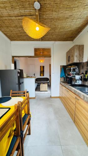 a large kitchen with a table and a dining room at La Passerelle des Empereurs in Albion