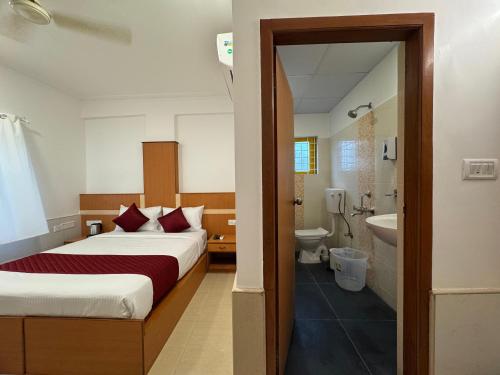 a hotel room with a bed and a bathroom at Zipp Lite - HAL Old Airport Road in Bangalore