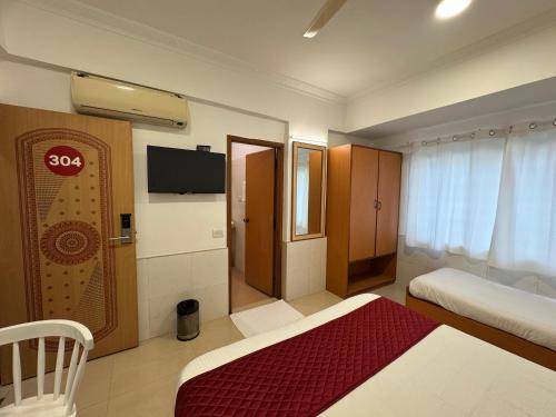 a hotel room with two beds and a flat screen tv at Zipp Lite - HAL Old Airport Road in Bangalore