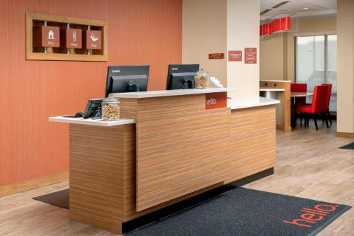 an office cubicle with a reception desk with two computers at TownePlace Suites by Marriott College Park in College Park