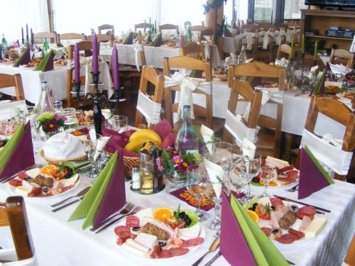 a long table with plates of food on it at Villa Katharina Bran in Bran