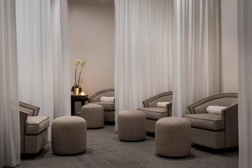 a waiting room with chairs and ottomans at The Ritz-Carlton St. Thomas in Benner