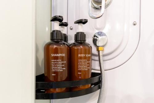 two bottles of shampoo in a medicine cabinet at NAMBA STAY 302 新今宮 Shiimamiya in Osaka