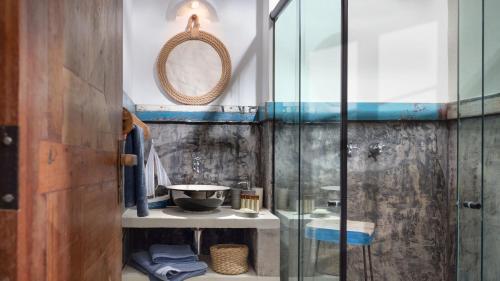 a bathroom with a glass shower and a sink at Pescador - Pousada de Charme in Jericoacoara