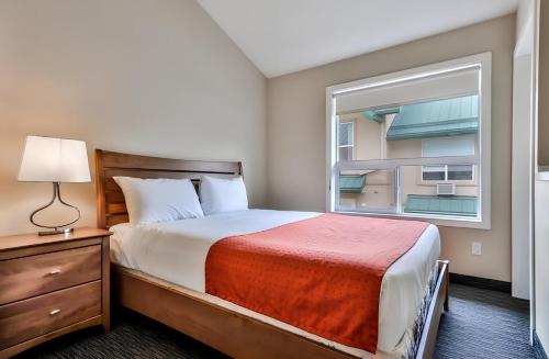 a small bedroom with a bed and a window at Mountain Surrounded Lodge in Harvie Height in Canmore