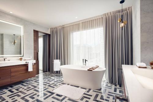 a bathroom with a tub and a large window at JW Marriott Hotel Monterrey Valle in Monterrey