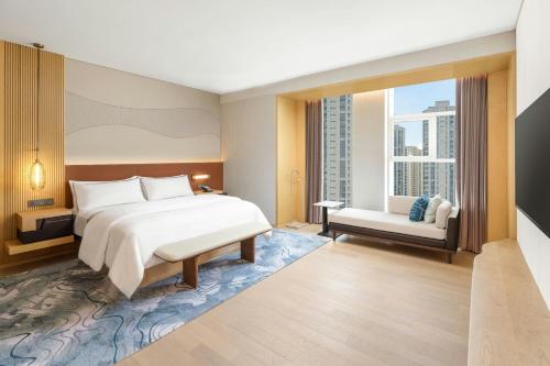 a bedroom with a large bed and a window at The Westin Wuhan Hanyang in Wuhan