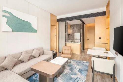 a living room with a couch and a table at The Westin Wuhan Hanyang in Wuhan