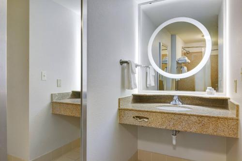 a bathroom with a sink and a mirror at SpringHill Suites Shreveport-Bossier City/Louisiana Downs in Bossier City