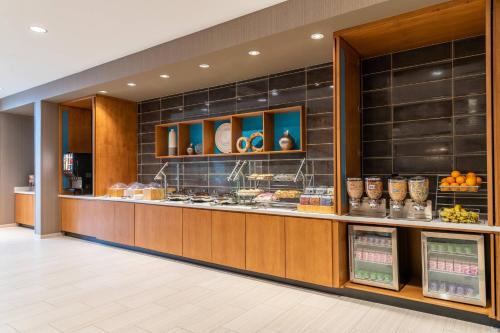 a buffet line in a restaurant with food at SpringHill Suites by Marriott Overland Park Leawood in Overland Park