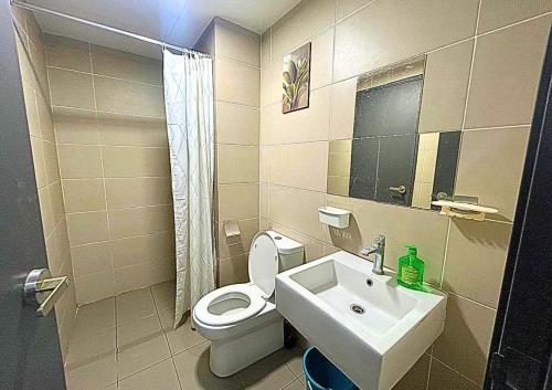 a small bathroom with a toilet and a sink at Cozy Urban Retreat in Emira, Mall Next Door #EM1 in Shah Alam
