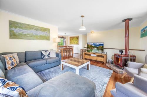 a living room with a couch and a table at Narrow Neck Retreat in Katoomba