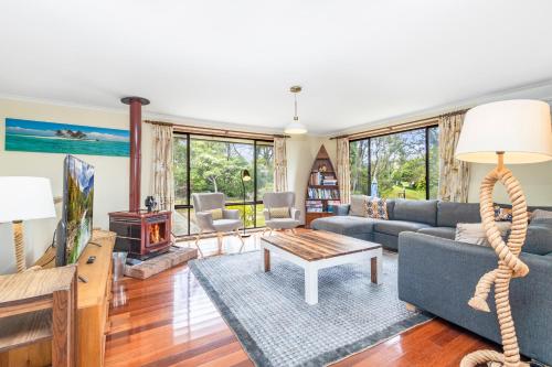 a living room with a couch and a table at Narrow Neck Retreat in Katoomba