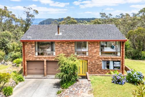 a brick house with a yellow garage at Narrow Neck Retreat in Katoomba
