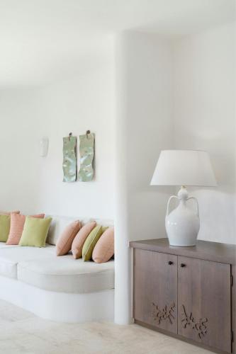 a living room with a couch and a table with a lamp at Cervo Hotel,Costa Smeralda Resort in Porto Cervo