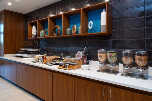 a kitchen with a counter with vases on it at SpringHill Suites by Marriott Kansas City Northeast in Kansas City