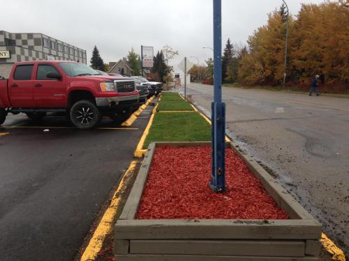 a red truck parked on the side of a street at Days Inn by Wyndham Sylvan Lake in Sylvan Lake