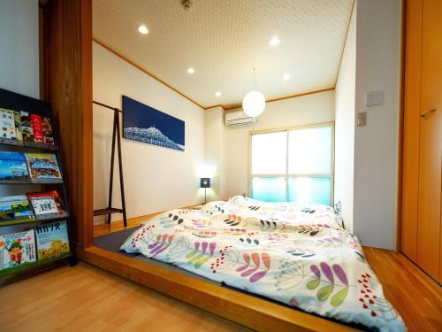 a bedroom with a bed with a large mirror at HOSTEL PAQ tokushima / Vacation STAY 35580 in Tokushima