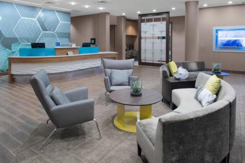a lobby with couches and chairs and a counter at SpringHill Suites by Marriott Kansas City Lenexa/City Center in Lenexa