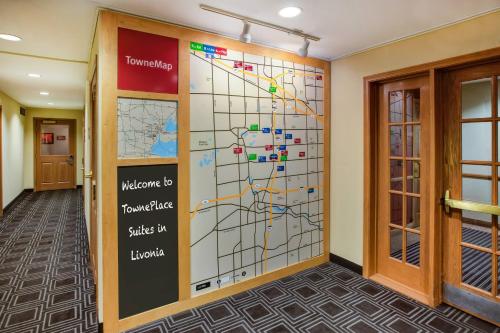 a wall mural of a subway map in a hallway at TownePlace Suites by Marriott Detroit Livonia in Livonia