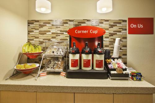 a counter with some bottles of wine and some food at TownePlace Suites by Marriott Detroit Livonia in Livonia