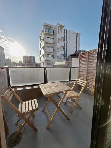 a table and two chairs on a balcony at 浅草スカイガーデンホテル in Tokyo