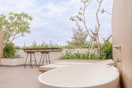 a bathroom with a white toilet on a balcony at Soul Boutique Hotel Phu Quoc in Phu Quoc