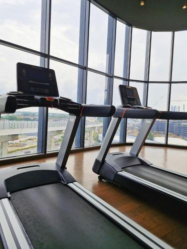 two treadmill machines in a room with windows at Luxury Accommodation Trio Bukit Tinggi in Klang