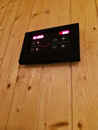 a black remote control on a wooden floor at Luxury Accommodation Trio Bukit Tinggi in Klang