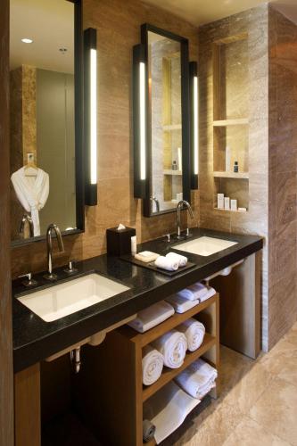 a bathroom with two sinks and a large mirror at JW Marriott Los Cabos Beach Resort & Spa in San José del Cabo