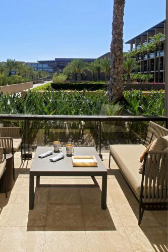 a patio with a table and chairs on a balcony at JW Marriott Los Cabos Beach Resort & Spa in San José del Cabo