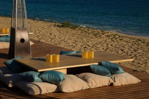 a picnic table on the beach with pillows under it at JW Marriott Los Cabos Beach Resort & Spa in San José del Cabo