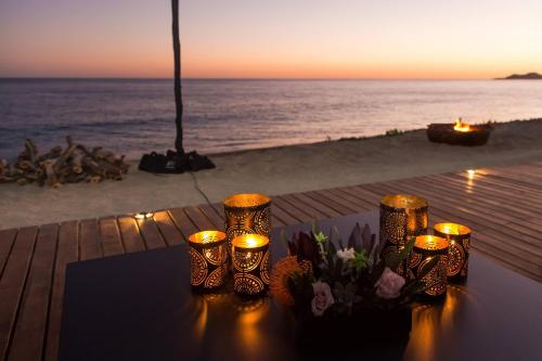 a table with candles and flowers on the beach at JW Marriott Los Cabos Beach Resort & Spa in San José del Cabo