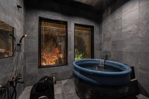a bathroom with a large blue tub in a room at JAPAVISTA Maverique in Osaka