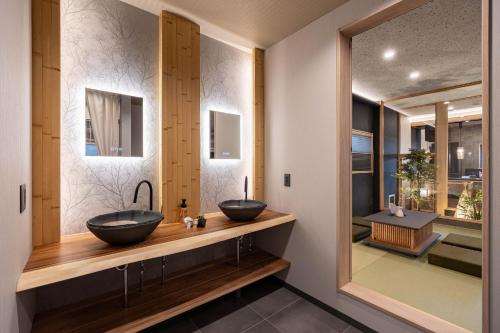 two sinks on a wooden counter in a bathroom at JAPAVISTA Maverique in Osaka