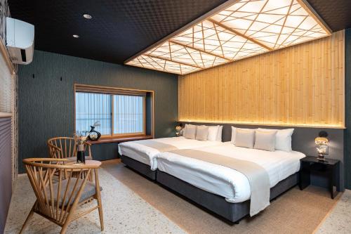 a bedroom with a large bed and a window at JAPAVISTA Maverique in Osaka