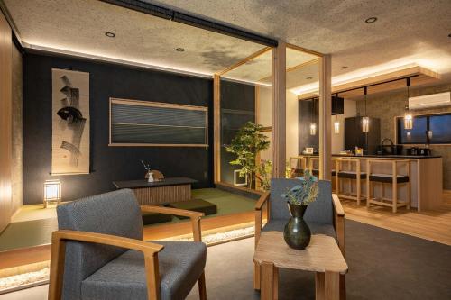 a living room with a table and chairs at JAPAVISTA Maverique in Osaka