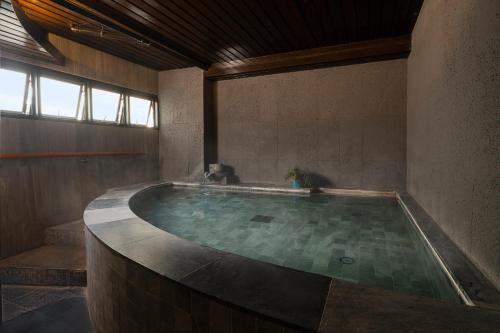 a large bath room with a large pool of water at Cross Vibe Bangkok Sukhumvit in Bangkok