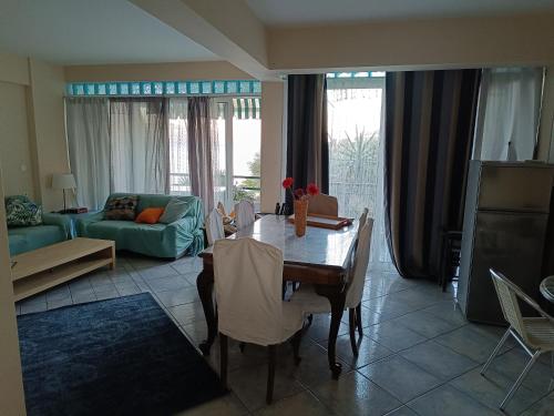 a living room with a table and a couch at Mare e Monti1 in Kamena Vourla