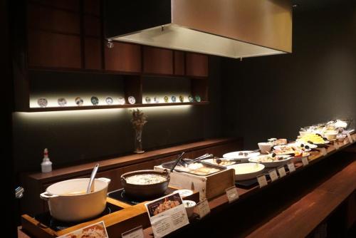 a buffet line with many different types of food at HOTEL AMANEK Kanazawa in Kanazawa