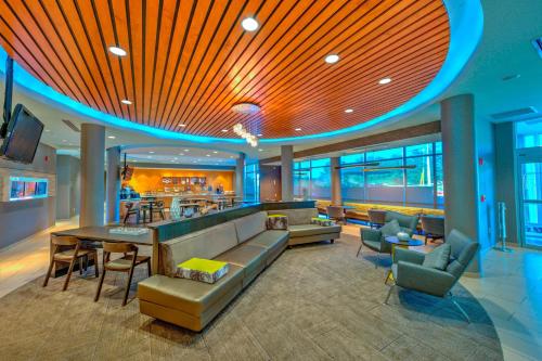 a lobby of a hotel with a couch and a bar at SpringHill Suites by Marriott Macon in Macon