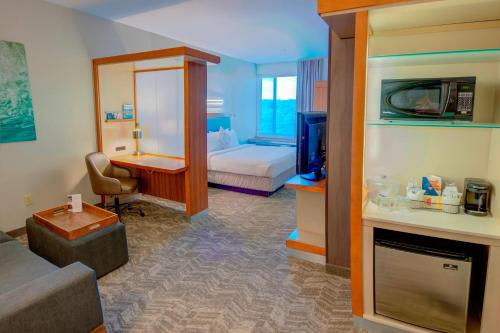 a hotel room with a bed and a living room at SpringHill Suites by Marriott Macon in Macon