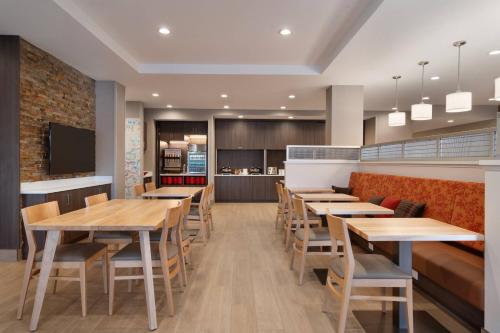 a dining room with wooden tables and chairs at TownePlace Suites by Marriott Logan in Logan