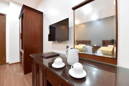 a hotel room with a mirror and a table with dishes at Gieng Ngoc Ocean moutain view Cat ba in Hai Phong