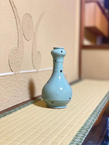 a blue vase sitting on top of a table at Kyoto Kiyomizu Machiya NAGOMI in Kyoto